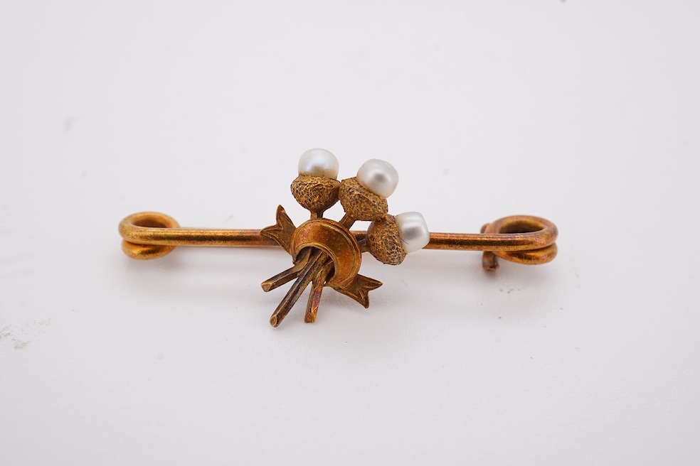 Five assorted items of jewellery including an early 20th century yellow metal and seed pearl set acorn bar brooch, 31mm, a similar yellow metal and split pearl ring ring (one missing), with diamond chip spacers, a modern